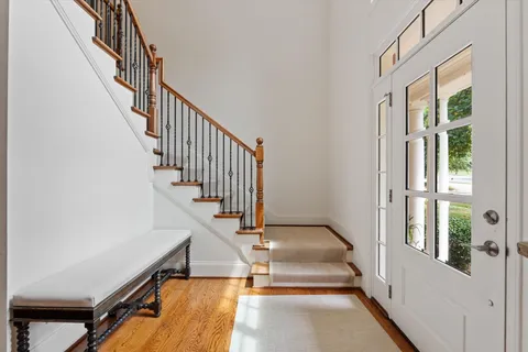 a view of entryway and hall with wooden floor