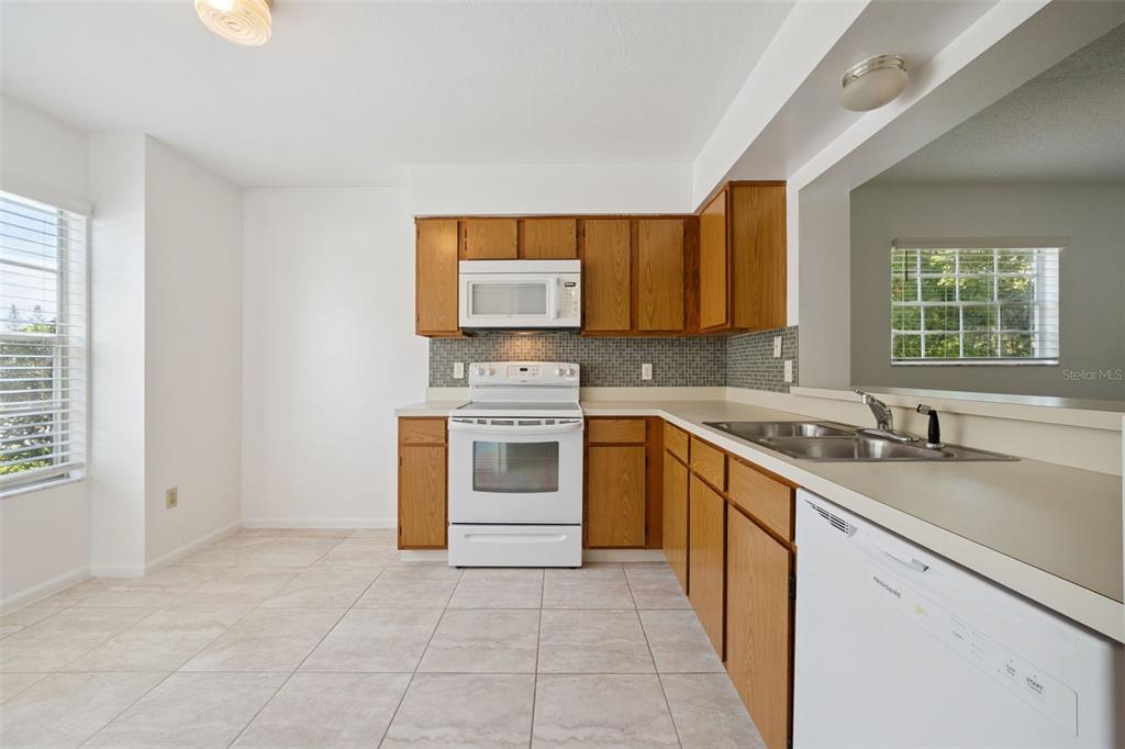 498 Green Spring Circle Winter Springs, FL 32708 - Photo 6 of 20 a kitchen with a stove sink and cabinets