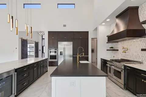 a living room with furniture and kitchen view