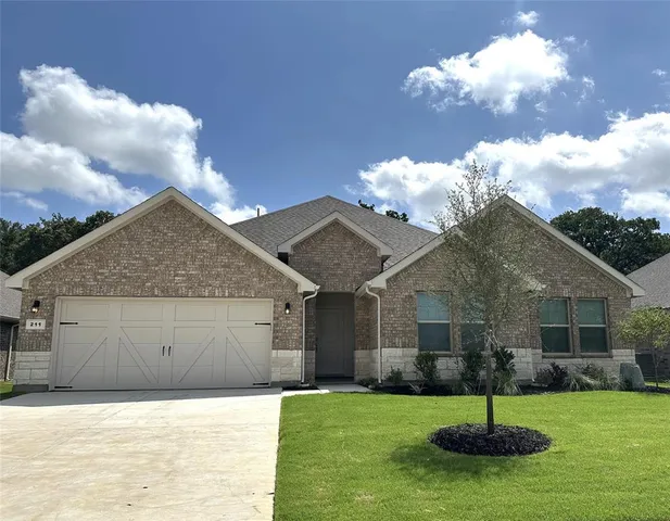 a view of a house with a garden and yard