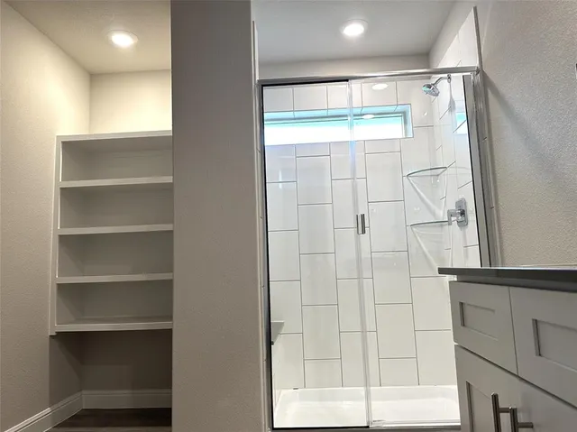 a bathroom with a glass shower door