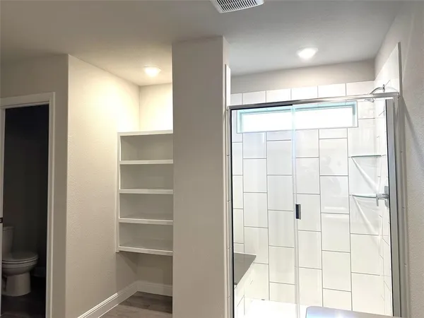 a bathroom with a glass shower door