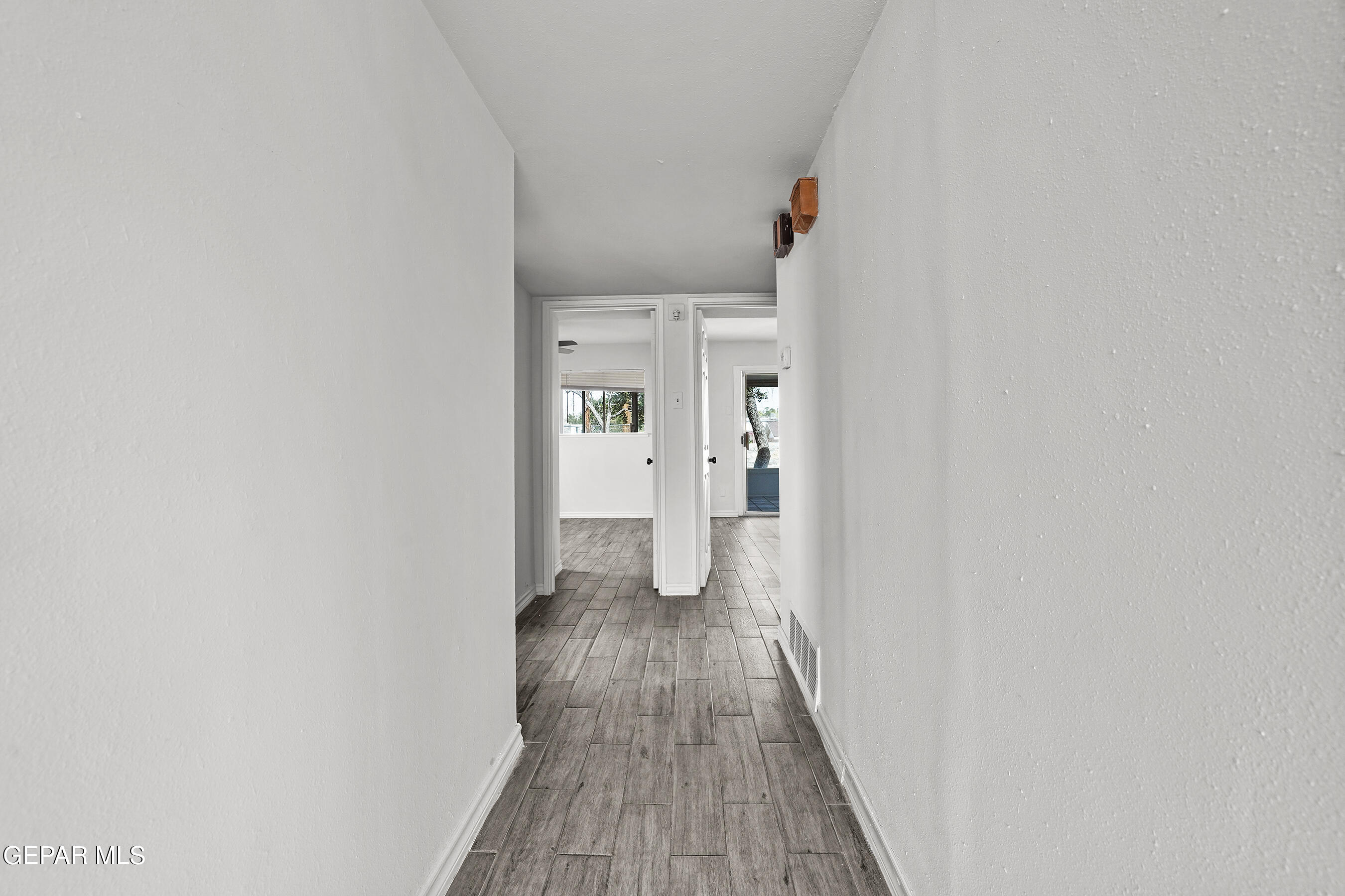 7809 Hemlock Street El Paso, TX 79925 - Photo 15 of 32 a view of a hallway with wooden floor and closet