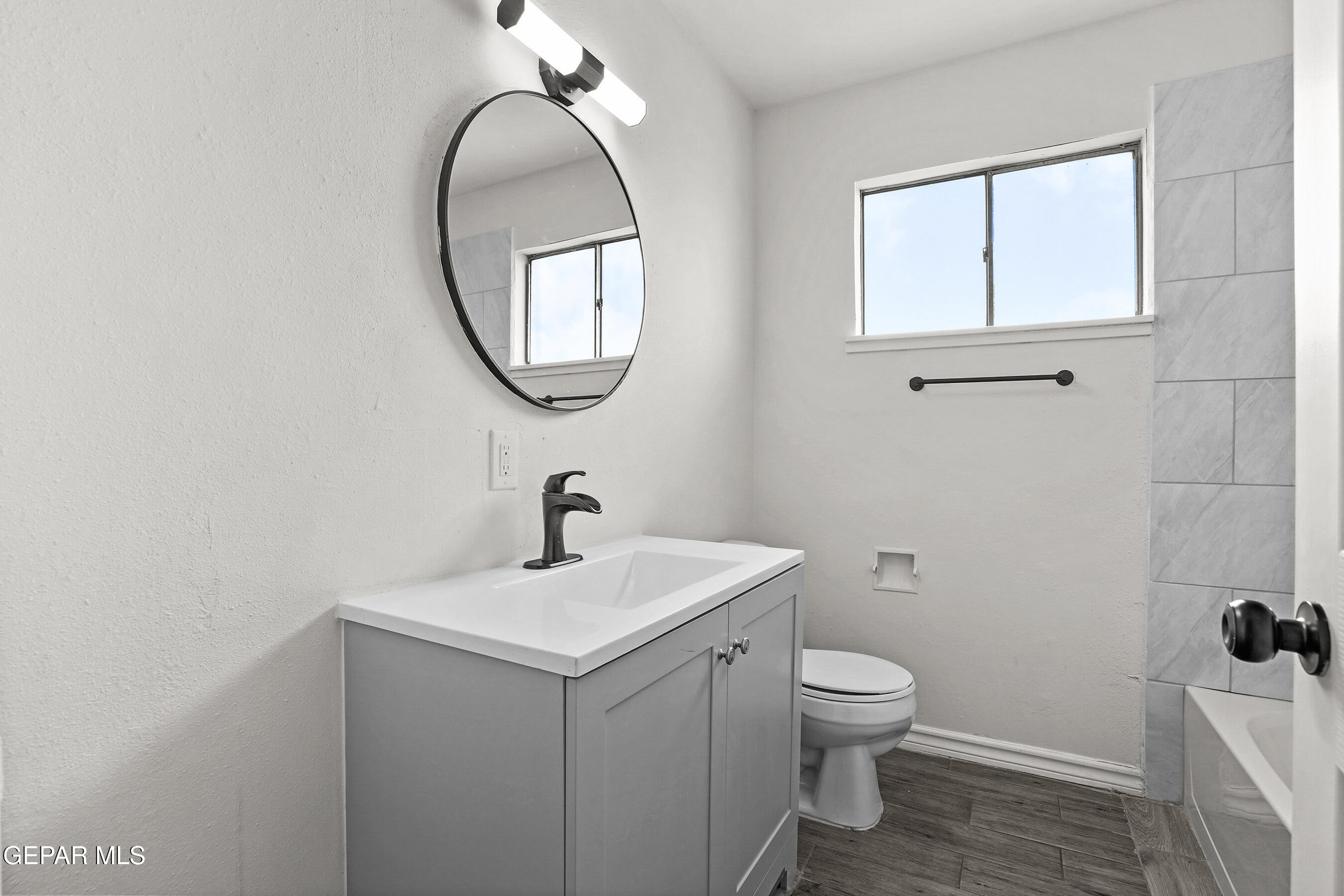 7809 Hemlock Street El Paso, TX 79925 - Photo 16 of 32 a bathroom with a toilet a sink and a mirror