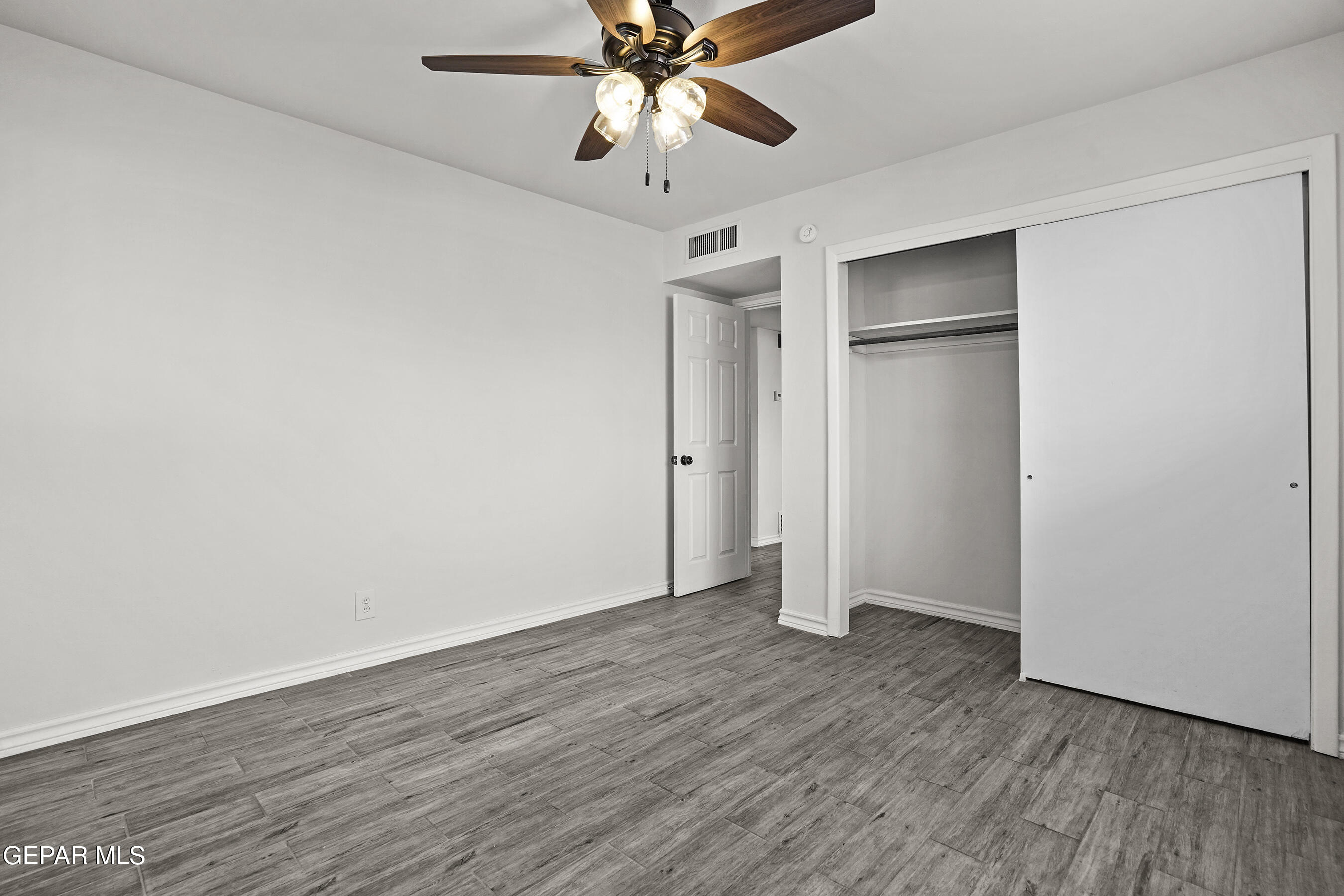 7809 Hemlock Street El Paso, TX 79925 - Photo 19 of 32 an empty room with wooden floor closet and windows