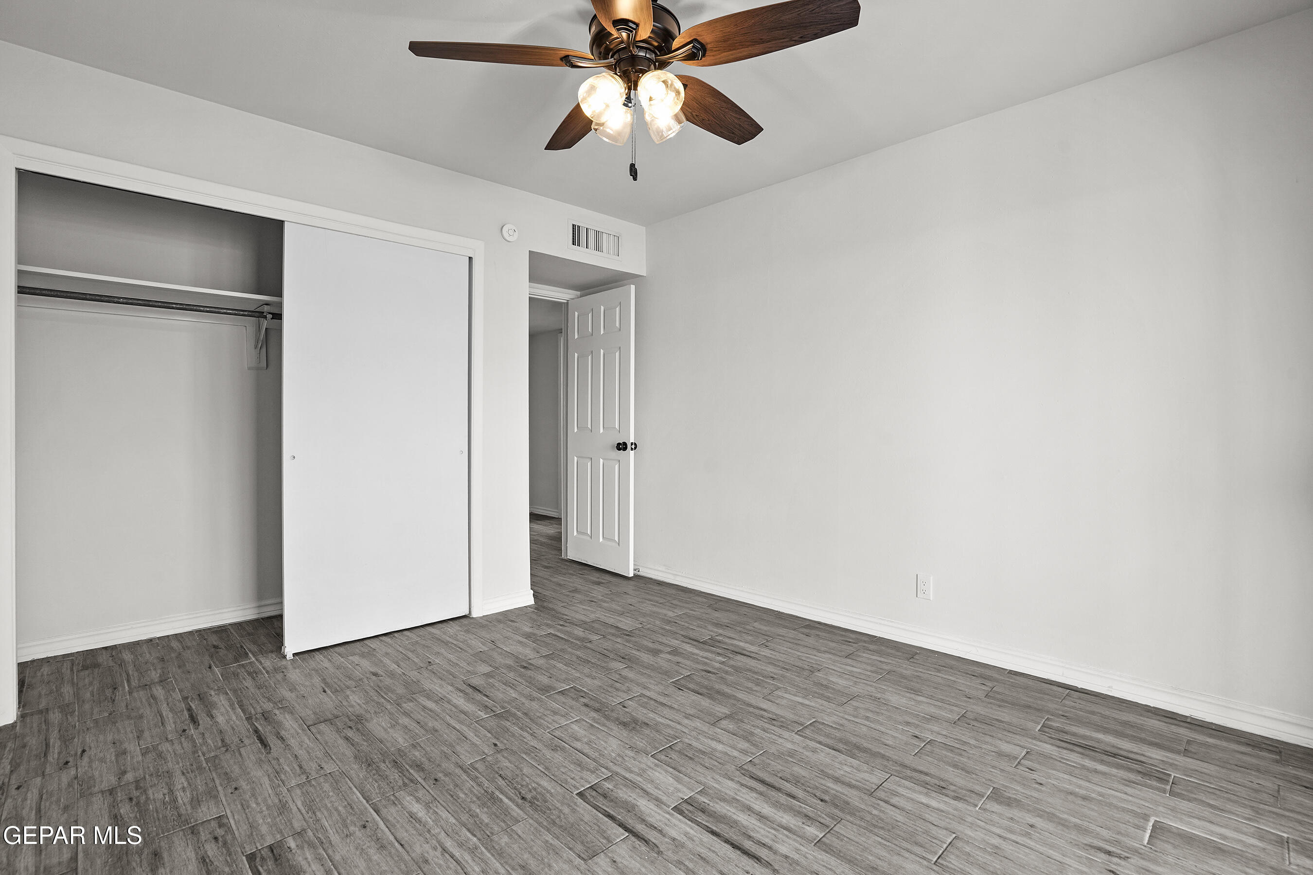 7809 Hemlock Street El Paso, TX 79925 - Photo 21 of 32 a view of an empty room with a window and wooden floor