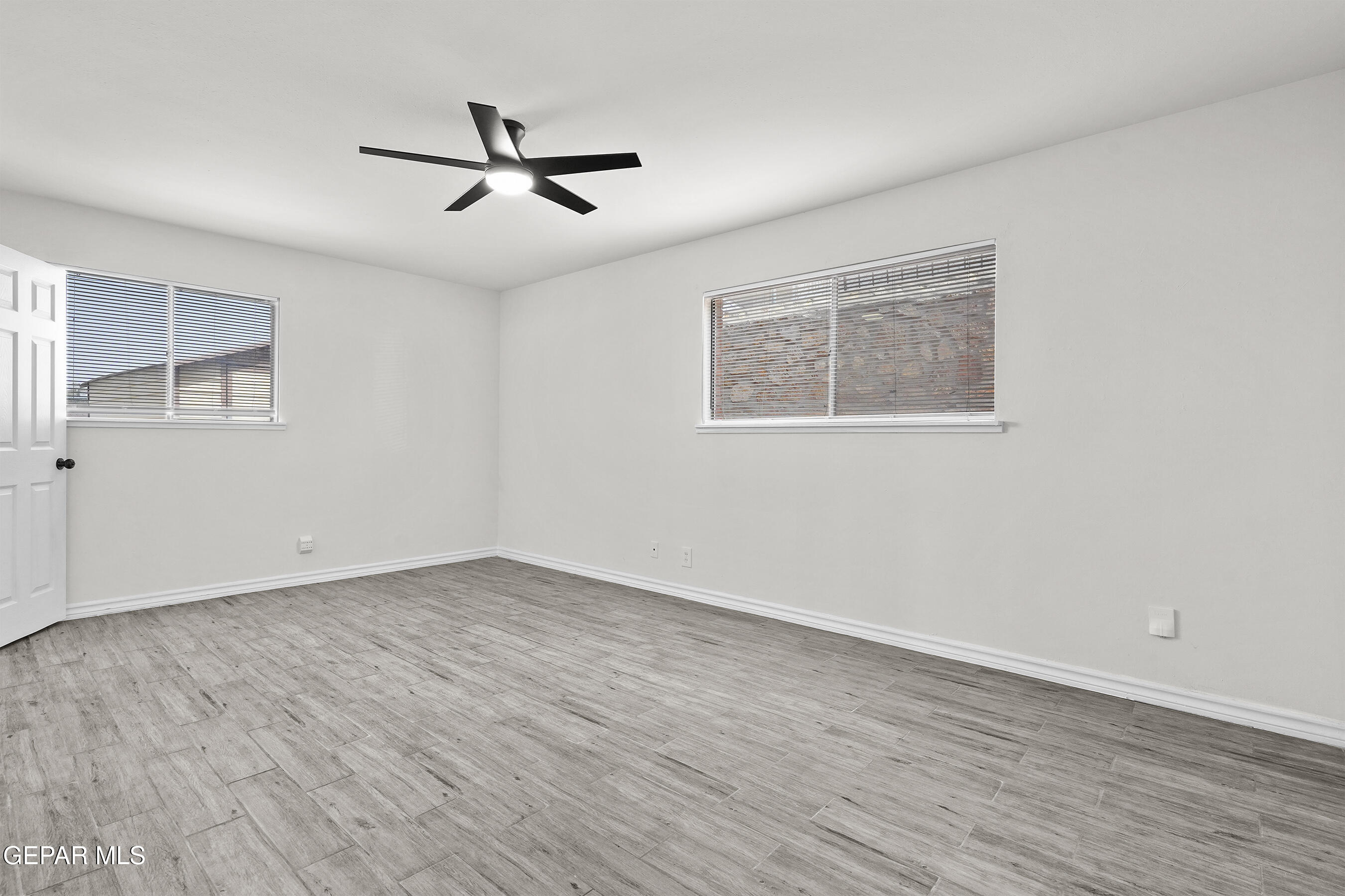 7809 Hemlock Street El Paso, TX 79925 - Photo 22 of 32 a view of empty room with wooden floor and fan