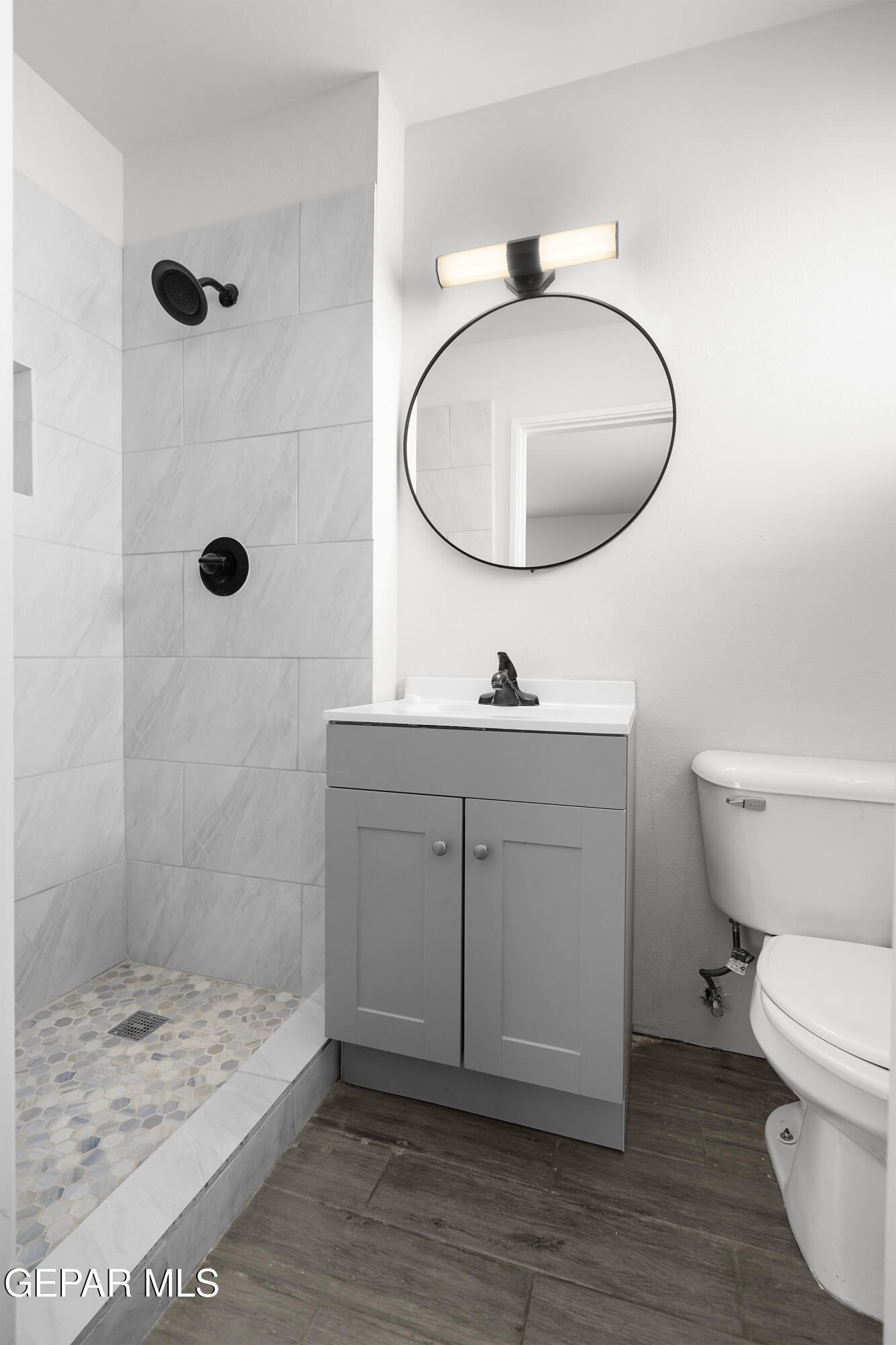 7809 Hemlock Street El Paso, TX 79925 - Photo 25 of 32 a bathroom with a toilet a sink a mirror and shower