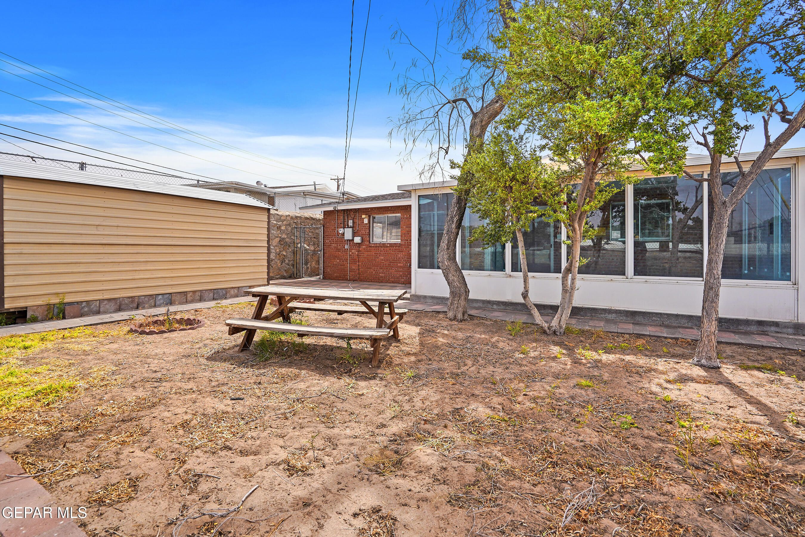 7809 Hemlock Street El Paso, TX 79925 - Photo 30 of 32 a backyard of a house with barbeque oven table and chairs