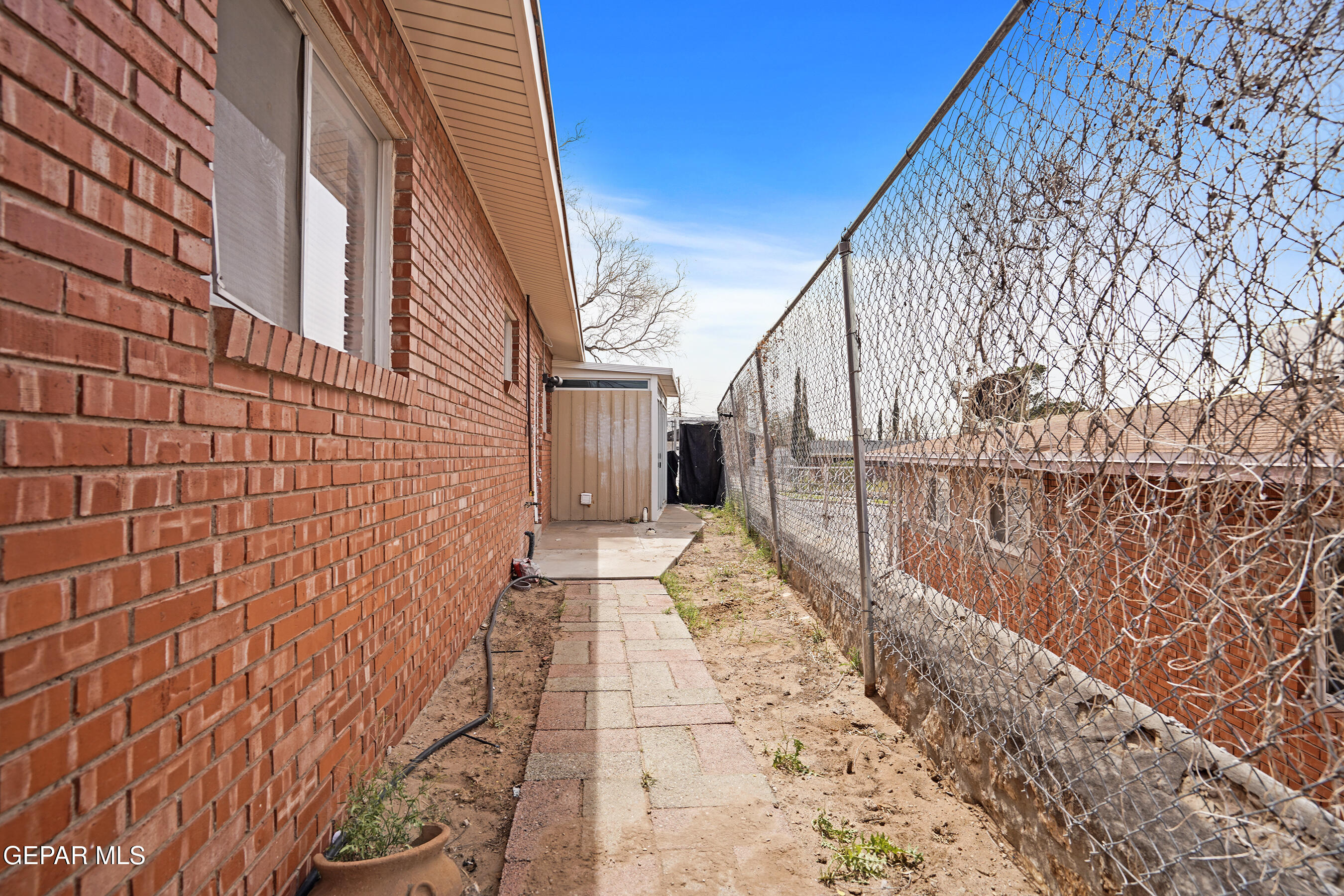 7809 Hemlock Street El Paso, TX 79925 - Photo 32 of 32 a view of a pathway with a building in the background