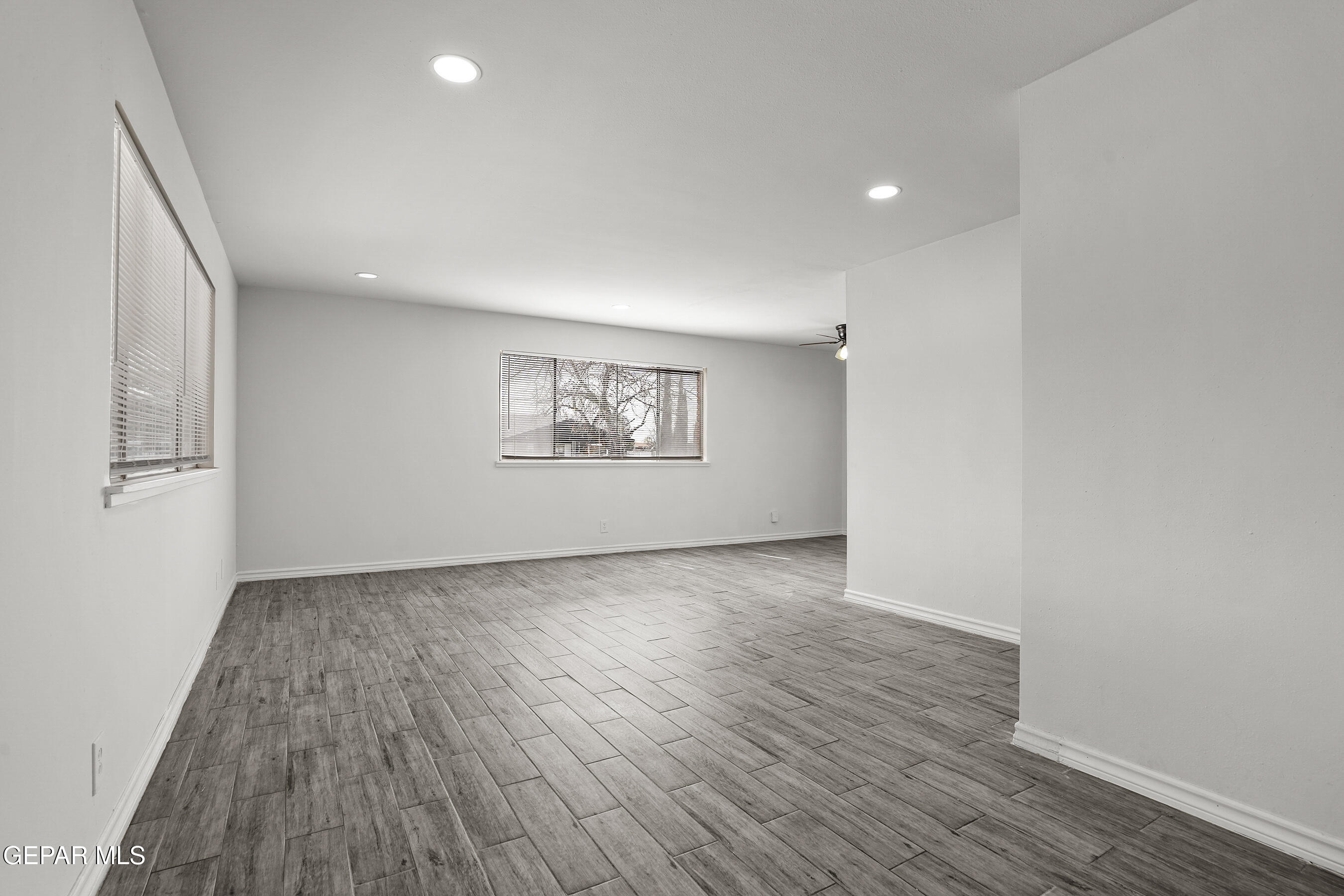 7809 Hemlock Street El Paso, TX 79925 - Photo 6 of 32 an empty room with wooden floor and windows