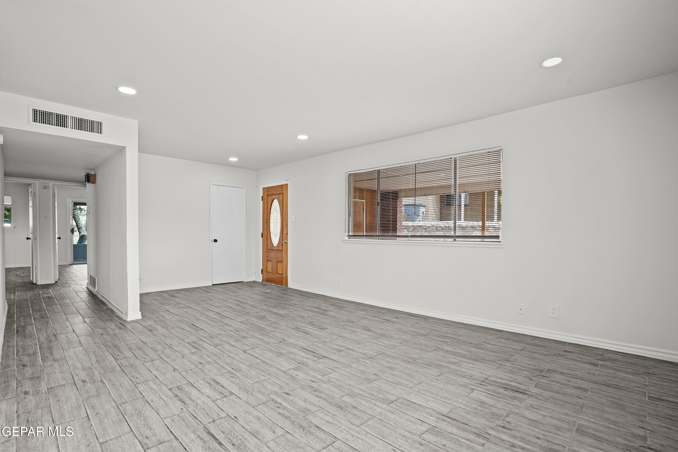 7809 Hemlock Street El Paso, TX 79925 - Photo 7 of 32 a view of an empty room with wooden floor and a window