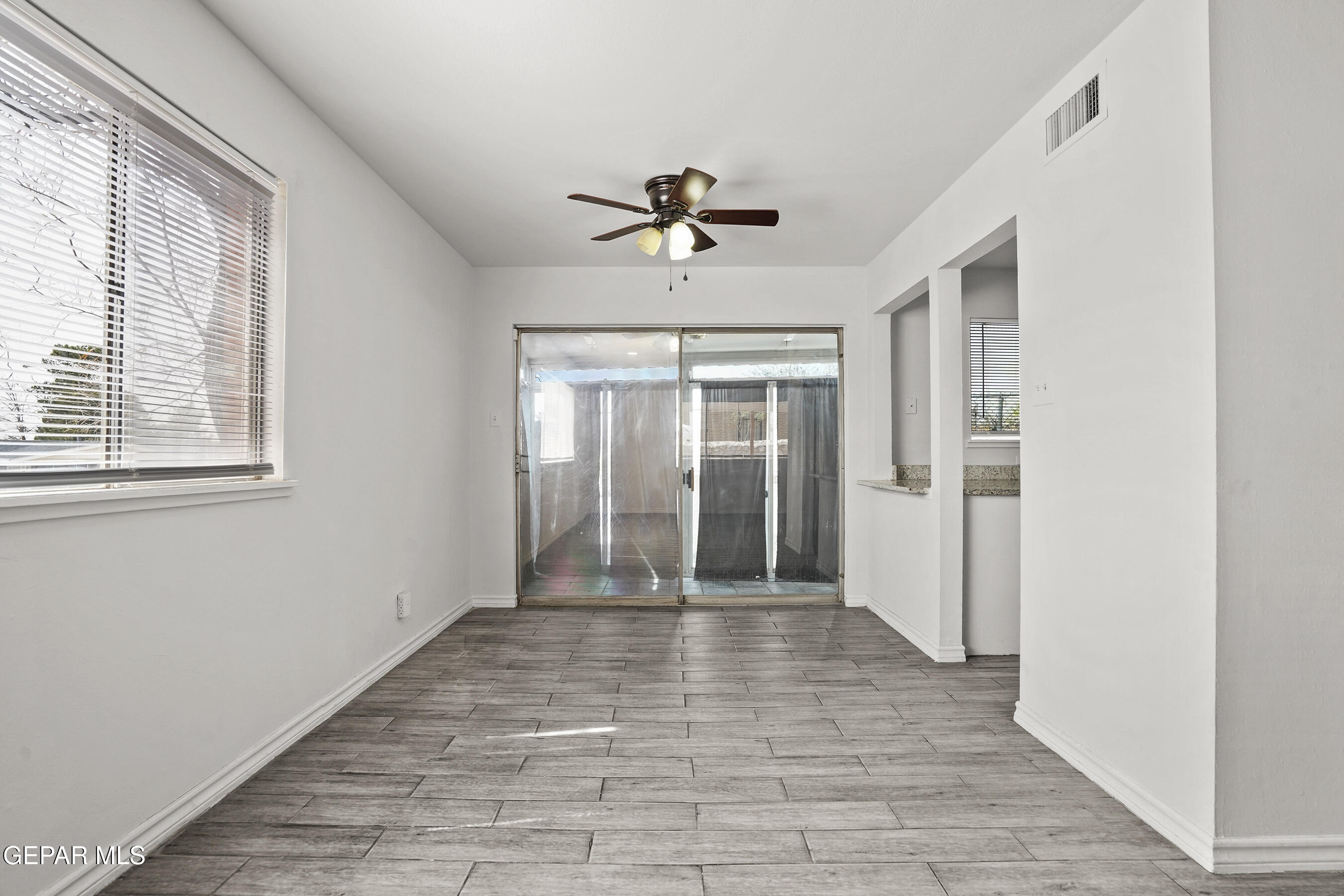 7809 Hemlock Street El Paso, TX 79925 - Photo 9 of 32 a view of empty room with wooden floor and fan