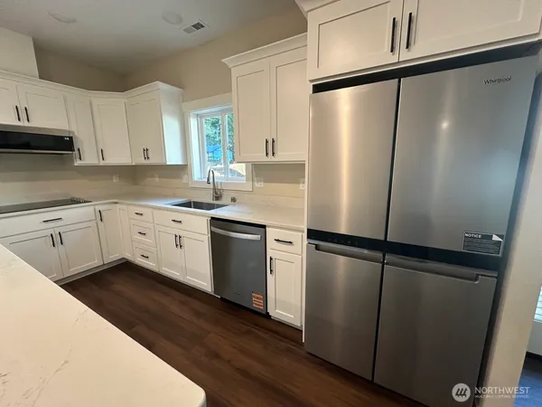 a kitchen with wooden cabinets and stainless steel appliances