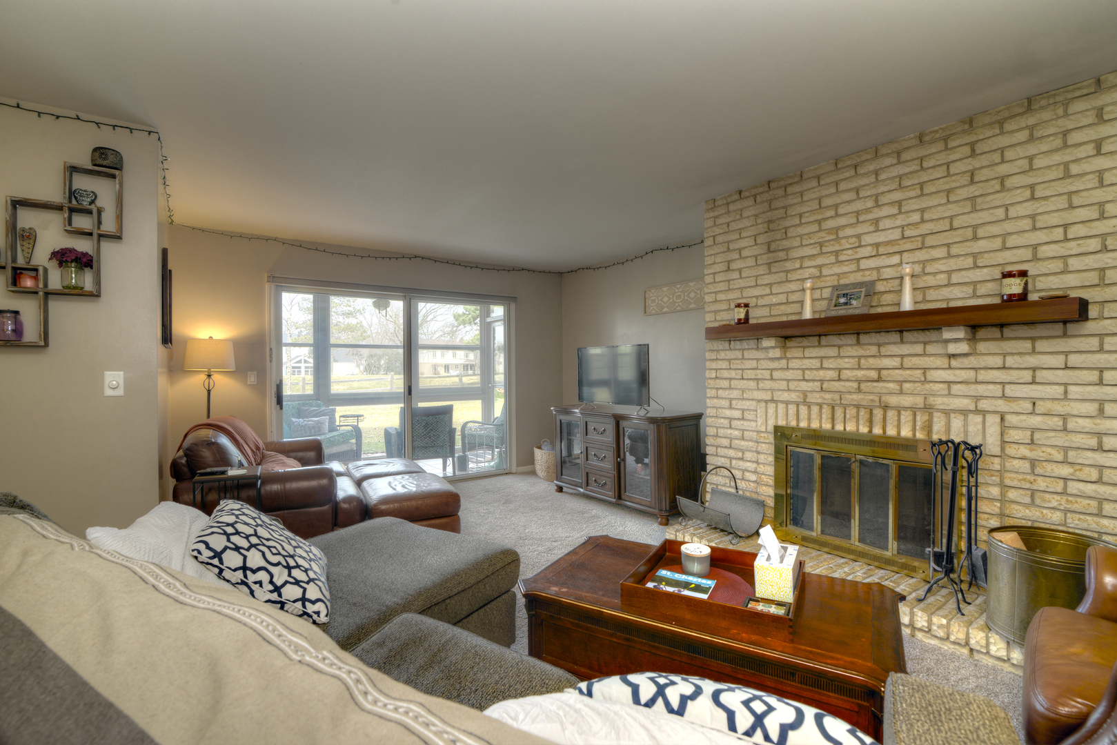116 Dunham Place Commons, Unit 116 St. Charles, IL 60174 - Photo 5 of 26 a living room with furniture and a fireplace