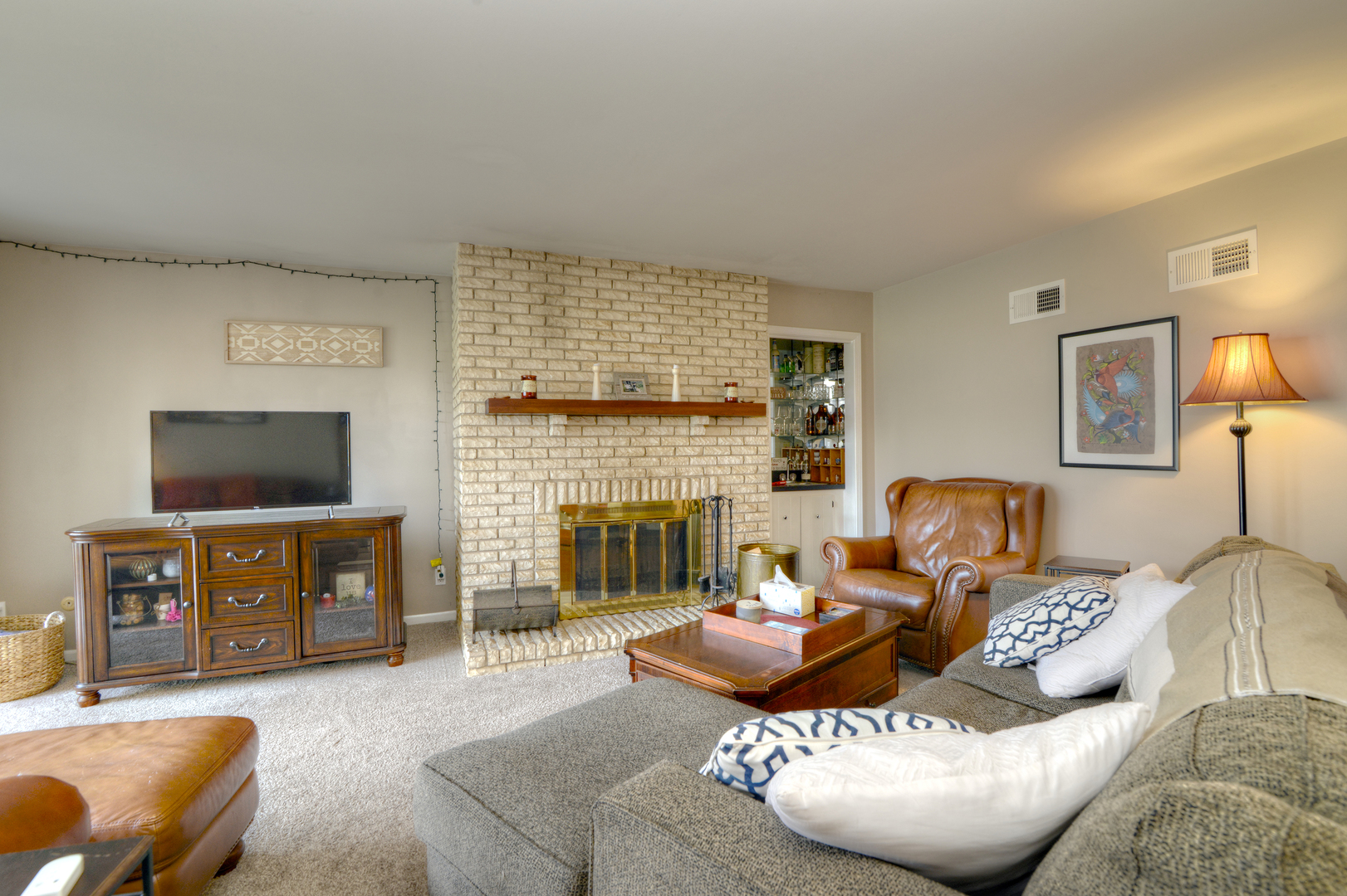 116 Dunham Place Commons, Unit 116 St. Charles, IL 60174 - Photo 6 of 26 a living room with furniture a flat screen tv and a fireplace