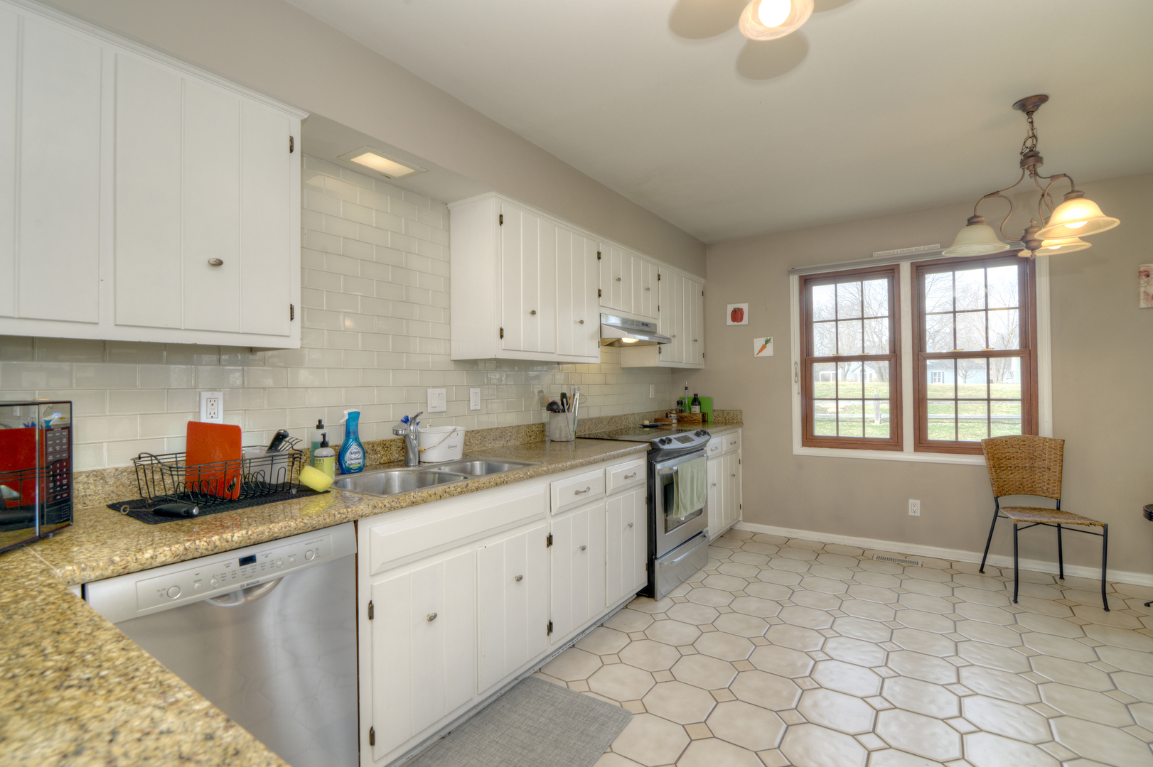 116 Dunham Place Commons, Unit 116 St. Charles, IL 60174 - Photo 7 of 26 a kitchen with sink cabinets and window