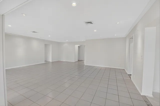 a kitchen with white cabinets stainless steel appliances and a window
