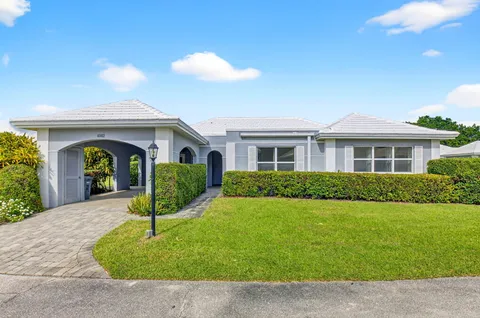 a view of a house with a backyard and a patio