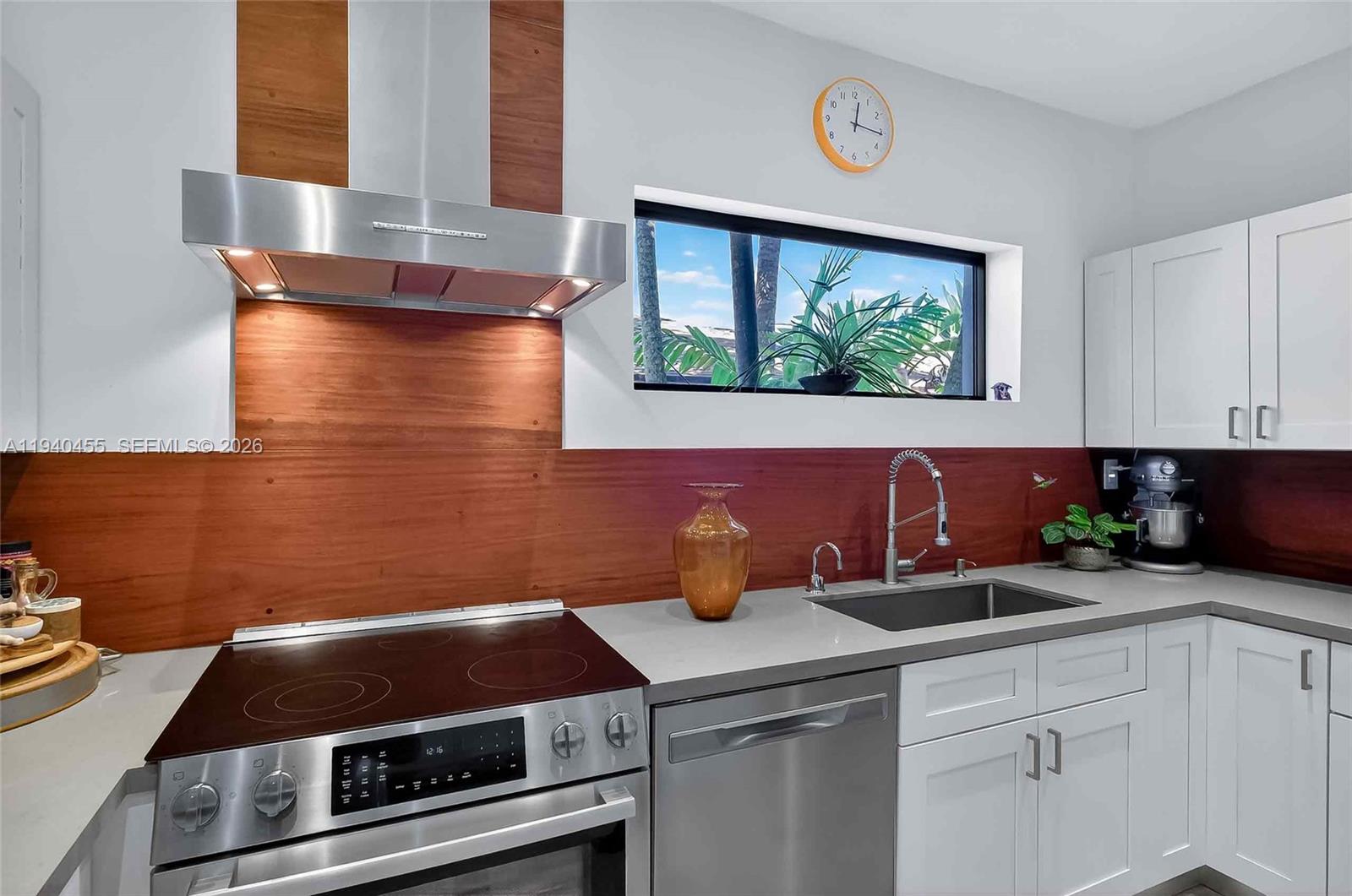 452 Southwest 21st Road Miami, FL 33129 - Photo 13 of 51 a kitchen with a sink and a stove