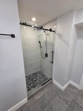 a bathroom with a glass shower door