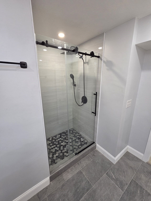 137 Centre Street, Unit B Boston, MA 02119 - Photo 3 of 10 a bathroom with a glass shower door