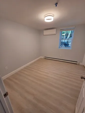 an empty room with windows and closet