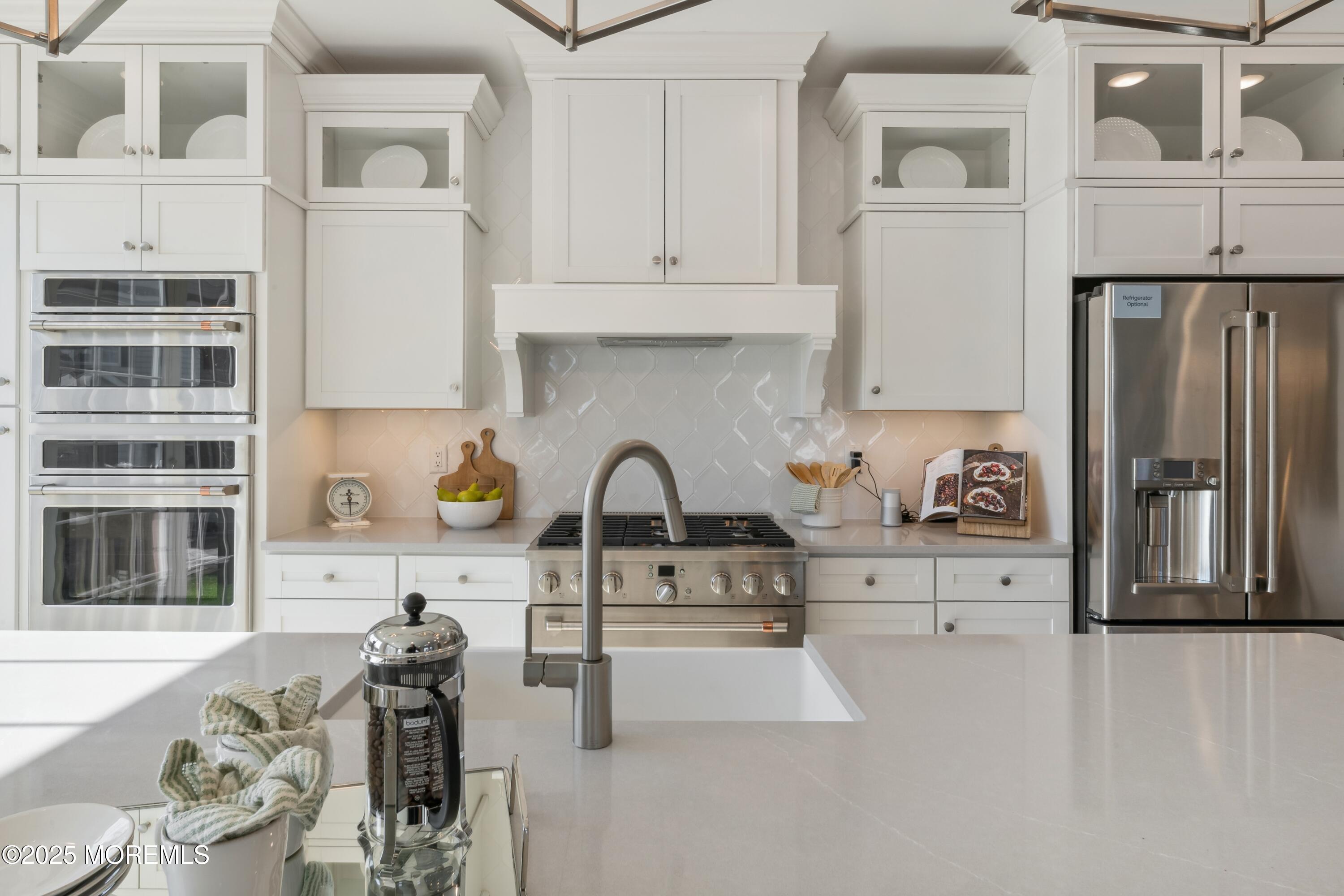 4061 Heron Drive Farmingdale, NJ 07727 - Photo 11 of 36 a kitchen with stainless steel appliances cabinets a sink and a counter top space