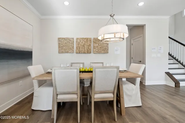 a dining room with furniture a chandelier and wooden floor