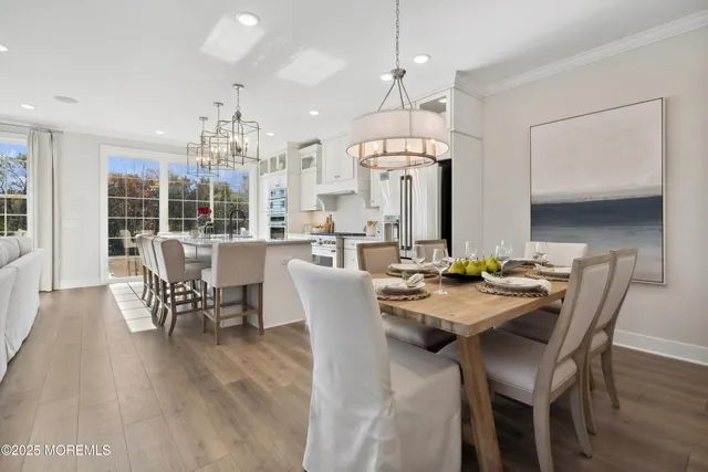 a view of a dining room with furniture and chandelier