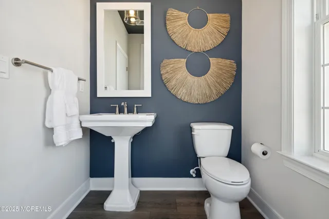 a bathroom with a sink mirror and toilet