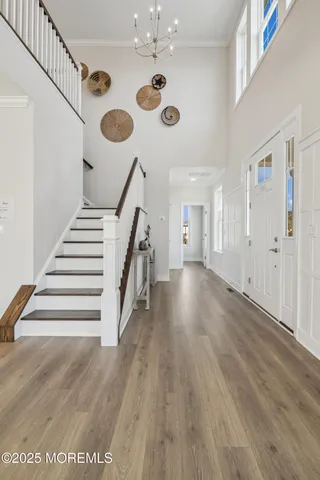 a view of entryway and hall with wooden floor