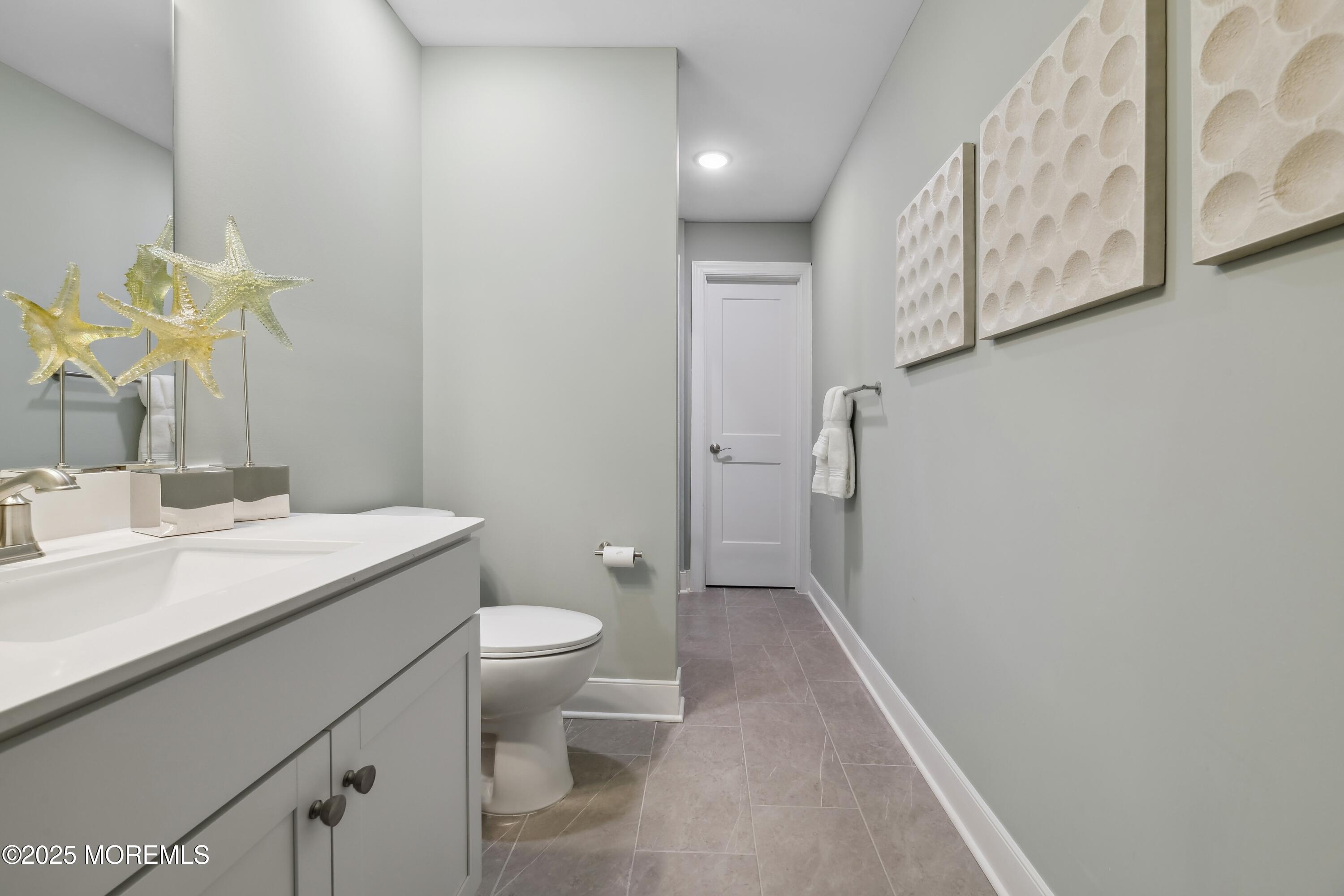 4061 Heron Drive Farmingdale, NJ 07727 - Photo 32 of 36 a bathroom with a granite countertop sink mirror vanity and toilet