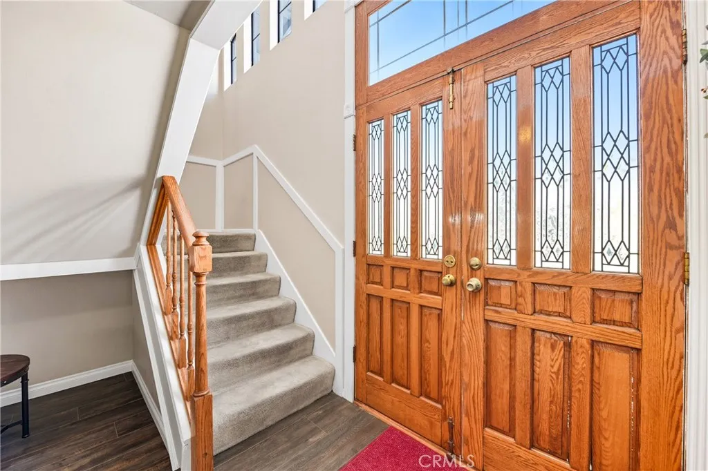 21902 Raintree Lane Lake Forest, CA 92630 - Photo 16 of 46 a view of staircase with wooden floor and white walls