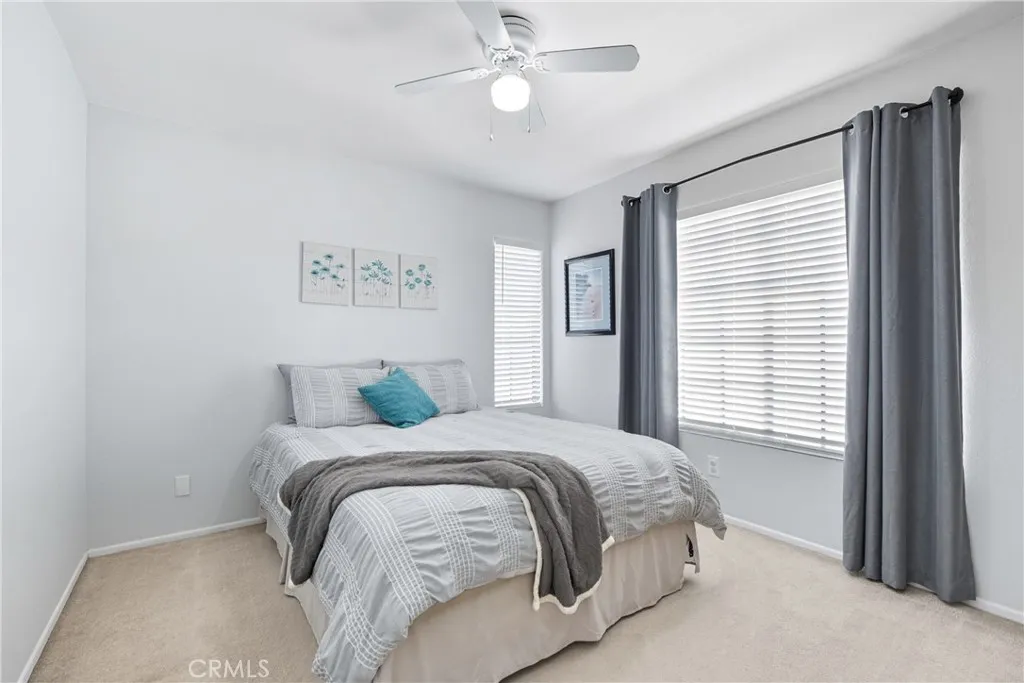 21902 Raintree Lane Lake Forest, CA 92630 - Photo 19 of 46 a bedroom with a large bed and a chandelier