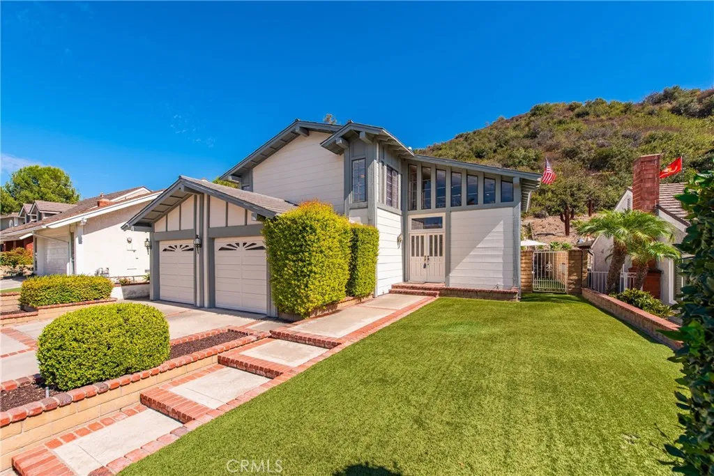 21902 Raintree Lane Lake Forest, CA 92630 - Photo 2 of 46 a front view of a house with a yard and garage
