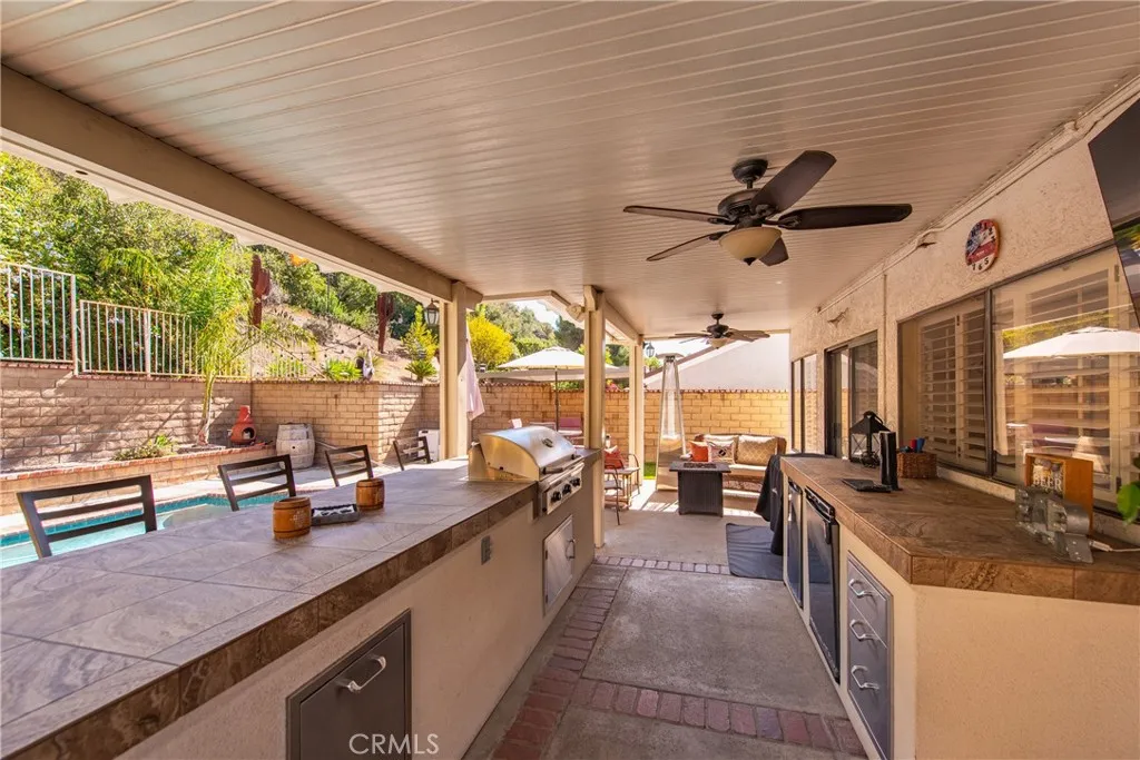 21902 Raintree Lane Lake Forest, CA 92630 - Photo 25 of 46 a large kitchen with stainless steel appliances kitchen island granite countertop a sink and cabinets