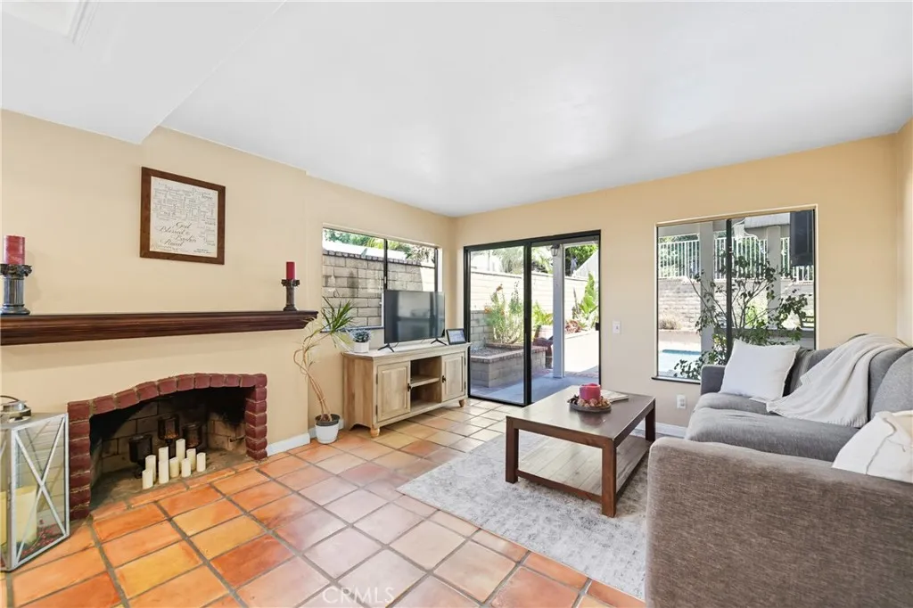 21902 Raintree Lane Lake Forest, CA 92630 - Photo 8 of 46 a living room with furniture a fireplace and a table