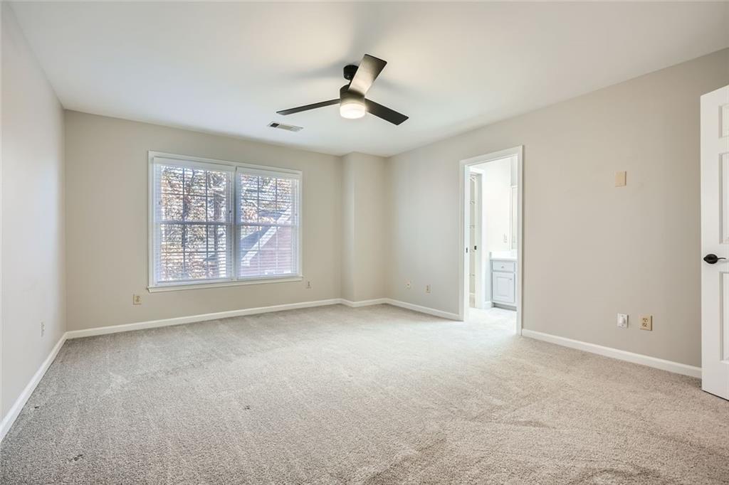 3330 Valley Vista Road Southeast Smyrna, GA 30080 - Photo 21 of 40 an empty room with windows and ceiling fan