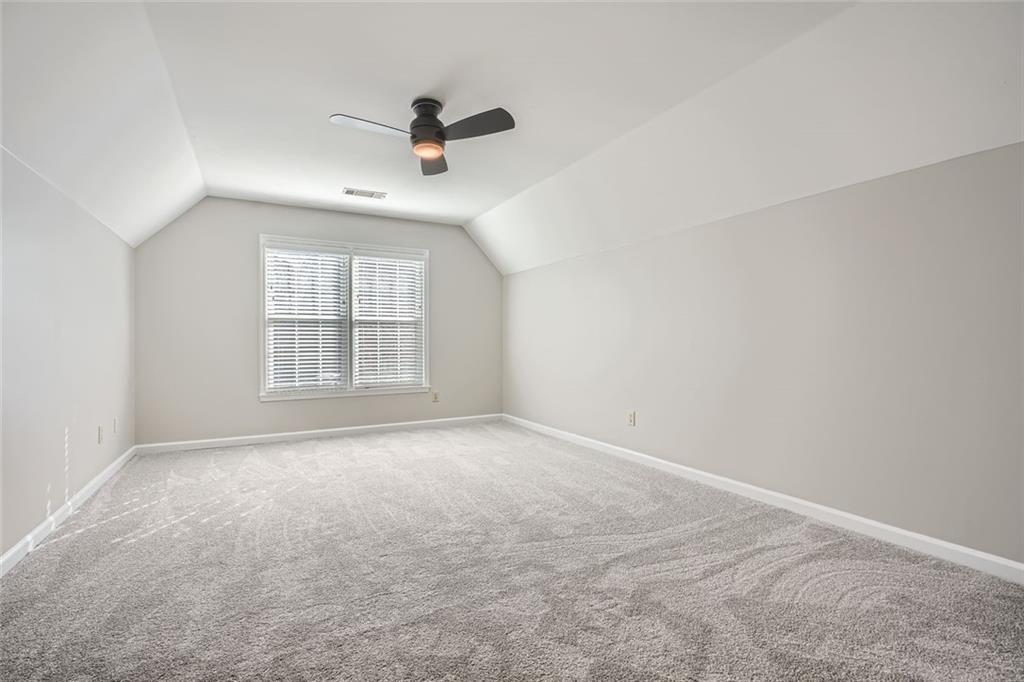 3330 Valley Vista Road Southeast Smyrna, GA 30080 - Photo 24 of 40 an empty room with windows and ceiling fan view