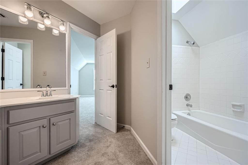 3330 Valley Vista Road Southeast Smyrna, GA 30080 - Photo 25 of 40 a bathroom with a double vanity sink mirror and bathtub