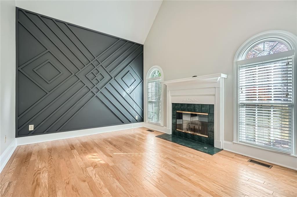 3330 Valley Vista Road Southeast Smyrna, GA 30080 - Photo 4 of 40 a view of empty room with wooden floor and fireplace