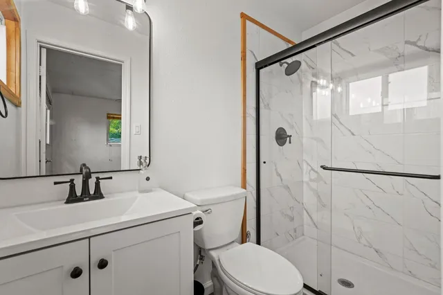 a view of a patio with table and chairs with wooden floor and fence