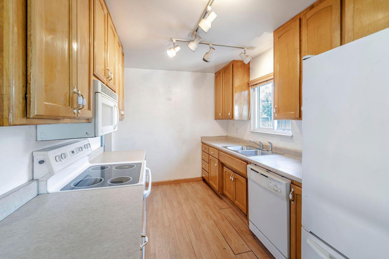 3331 Taylor Road Loomis, CA 95650 - Photo 58 of 97 a kitchen with a stove a sink and wooden floor