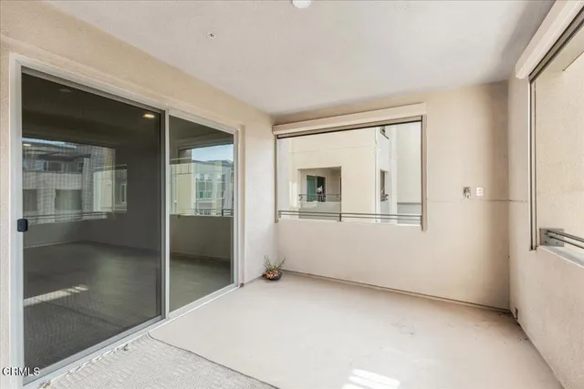 a view of empty room with cabinet and mirrors
