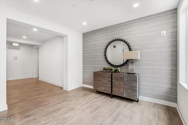 a view of a livingroom with wooden floor and window