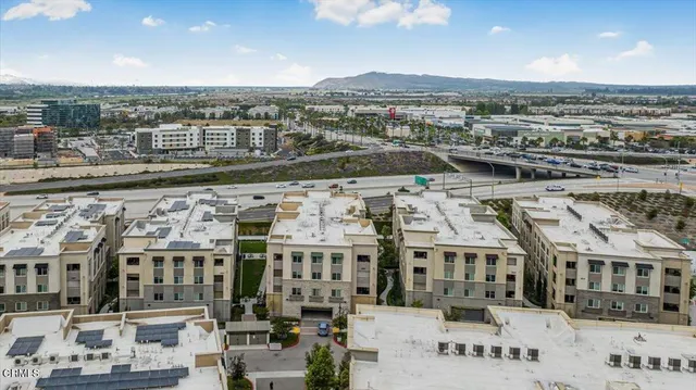 a view of a patio with table and chairs potted plants and large tree