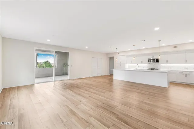 a view of kitchen and hall with wooden floor