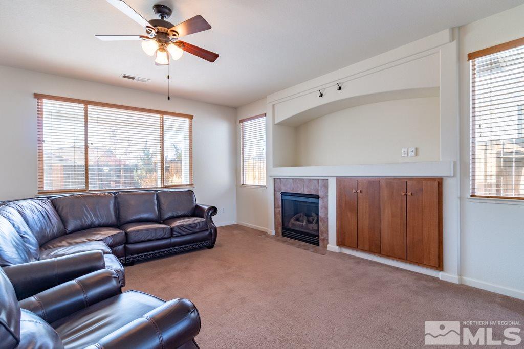9575 Navigator Drive Reno, NV 89521 - Photo 2 of 13 a living room with furniture a fireplace and a window