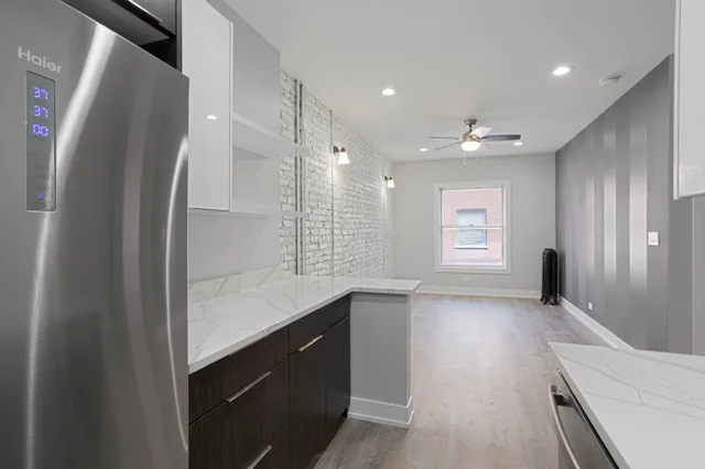 a kitchen with stainless steel appliances granite countertop a refrigerator and a sink